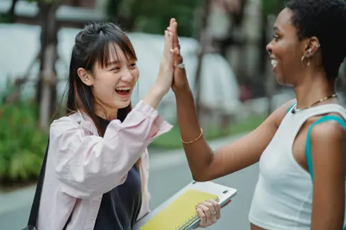 two female high school students high-fiving NSHSS