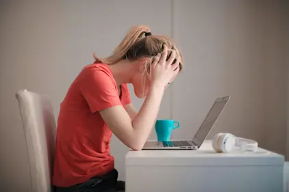 girl looking stressed at a laptop